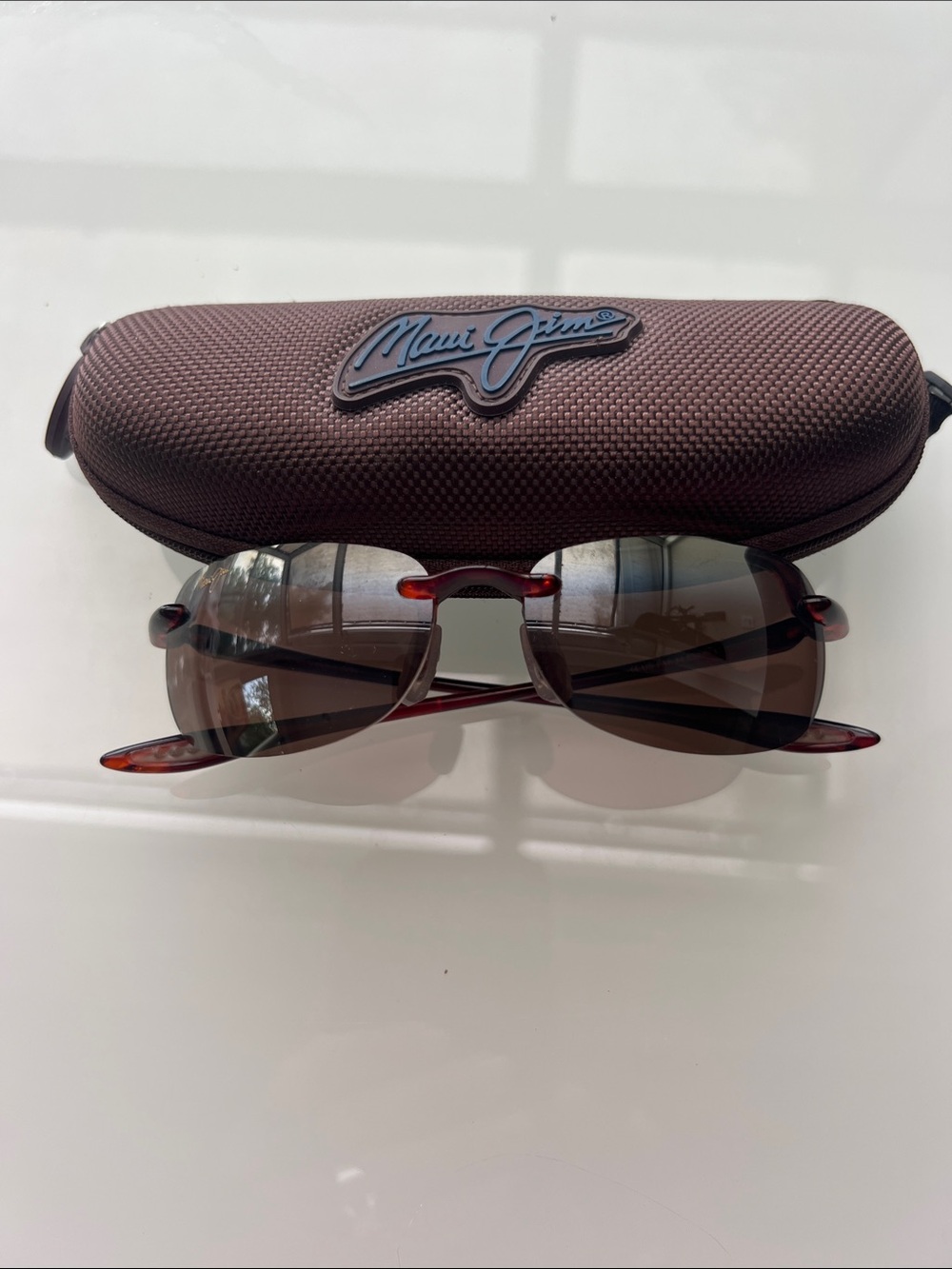 Maui Jim Brown Rimless Sunglasses with Tortoise Temples and Blue Logo Case